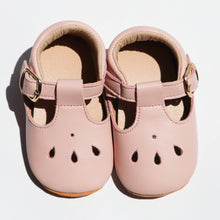 Load image into Gallery viewer, Brooklyn T-bar moccasins for baby girls, featuring soft leather with delicate teardrop cut-out details, adjustable buckle strap, and cushioned ankles for comfort. Available in soft suede soles for younger sizes (0-12 months) and flexible rubber soles for older sizes (12-24 months), these stylish and lightweight shoes are perfect for special occasions and everyday wear."