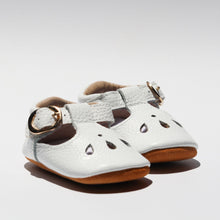 Load image into Gallery viewer, Brooklyn T-bar moccasins for baby girls, featuring soft leather with delicate teardrop cut-out details, adjustable buckle strap, and cushioned ankles for comfort. Available in soft suede soles for younger sizes (0-12 months) and flexible rubber soles for older sizes (12-24 months), these stylish and lightweight shoes are perfect for special occasions and everyday wear."
