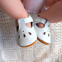Load image into Gallery viewer, Brooklyn T-bar moccasins for baby girls, featuring soft leather with delicate teardrop cut-out details, adjustable buckle strap, and cushioned ankles for comfort. Available in soft suede soles for younger sizes (0-12 months) and flexible rubber soles for older sizes (12-24 months), these stylish and lightweight shoes are perfect for special occasions and everyday wear."