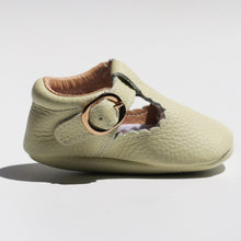 Load image into Gallery viewer, Manhattan T-Bar Moccasins – Modern leather moccasins with classic adjustable t-bar straps and side buckles. Featuring soft, flexible soles for comfort and freedom of movement, these moccasins have a scalloped edging detail, cushioned ankles, and cotton insoles. Ideal for little feet, they provide a barefoot feel with stylish and functional design.